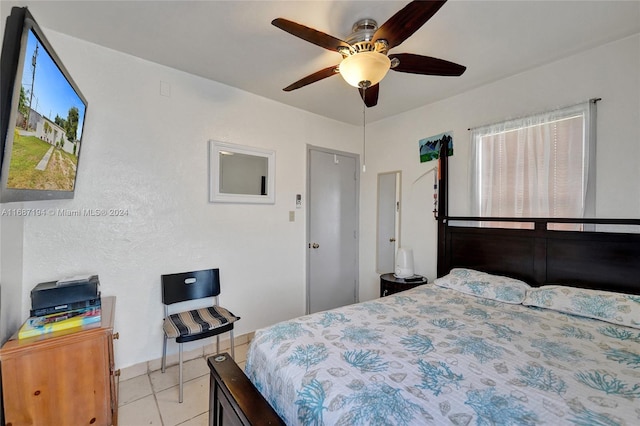 tiled bedroom with ceiling fan