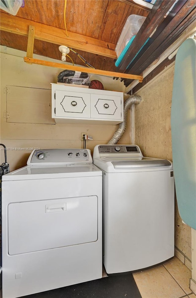 laundry room featuring cabinets and washing machine and dryer