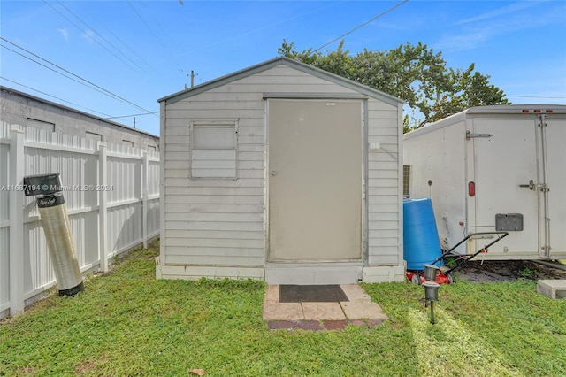 view of outdoor structure with a lawn