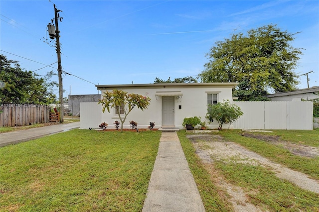 bungalow-style house featuring a front yard