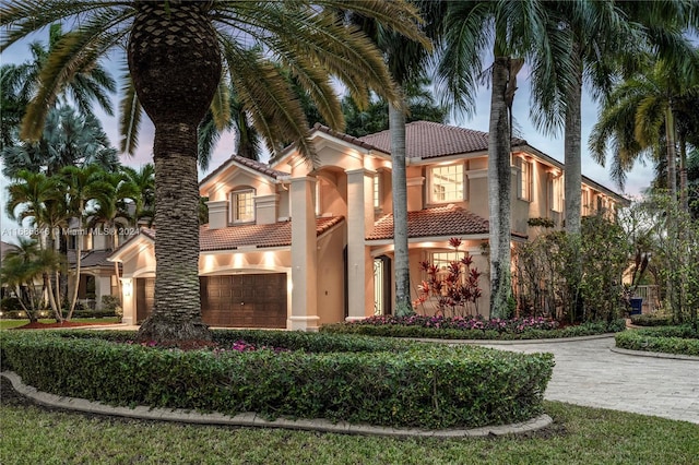 mediterranean / spanish-style home featuring a garage