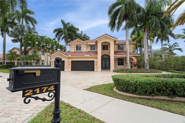 mediterranean / spanish-style home with a garage