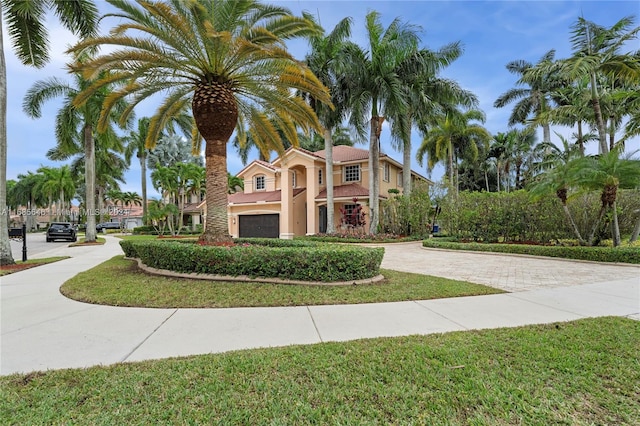 mediterranean / spanish home with a front yard and a garage