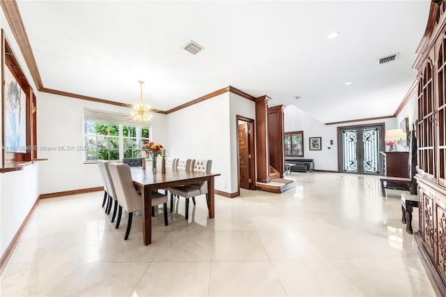 dining space with ornamental molding, a chandelier, and french doors