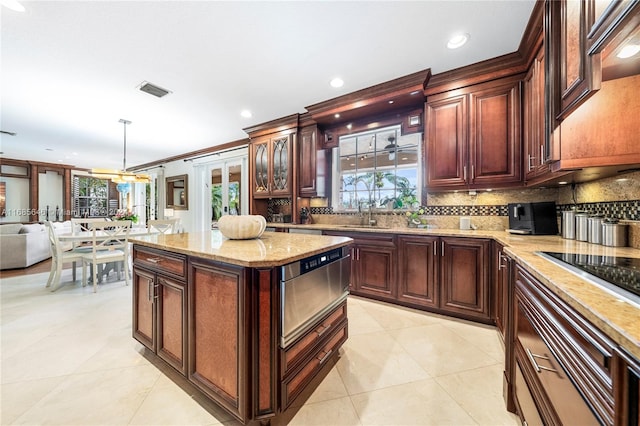 kitchen with light tile patterned flooring, backsplash, black electric cooktop, pendant lighting, and crown molding