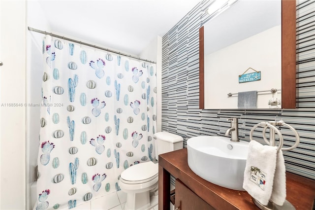 full bathroom featuring toilet, vanity, tile patterned floors, and shower / tub combo