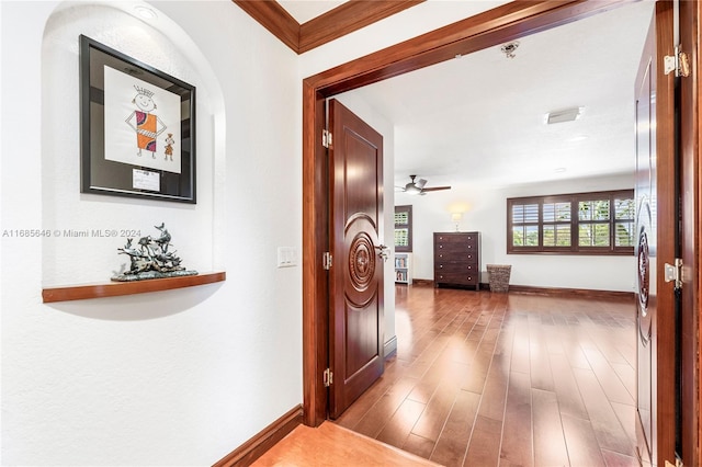 corridor featuring crown molding and light wood-type flooring