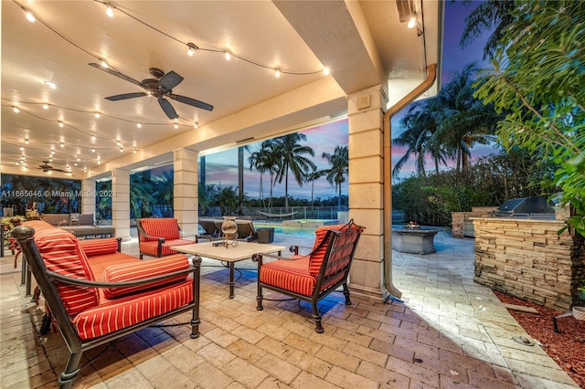 patio terrace at dusk featuring ceiling fan