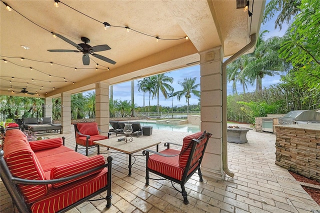 view of patio featuring an outdoor kitchen, an outdoor hangout area, grilling area, and ceiling fan