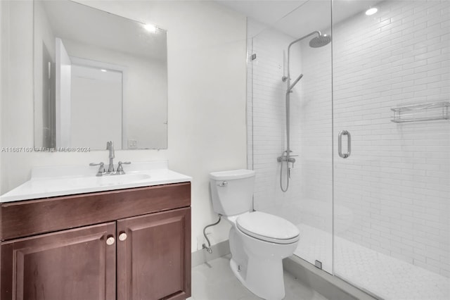 bathroom with vanity, toilet, and a shower with shower door