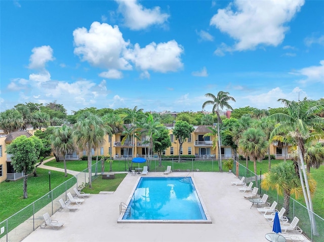 view of pool with a patio and a yard