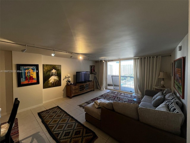 living room featuring rail lighting and light tile patterned floors