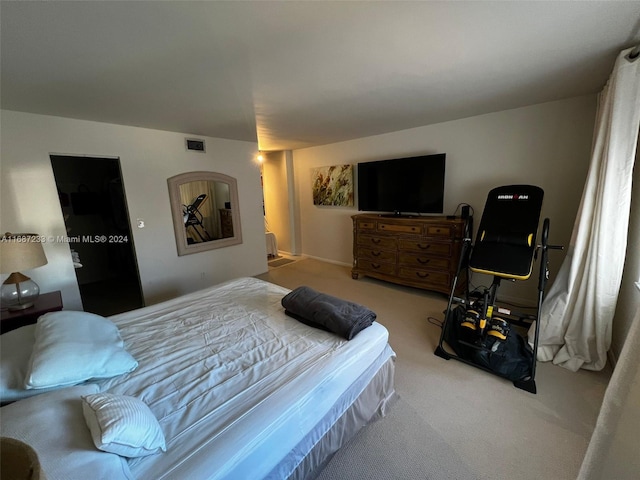 bedroom featuring light colored carpet