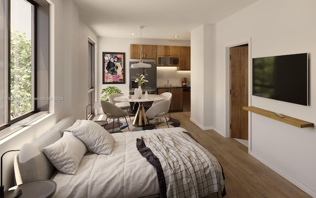 bedroom featuring sink, dark wood-type flooring, and black fridge