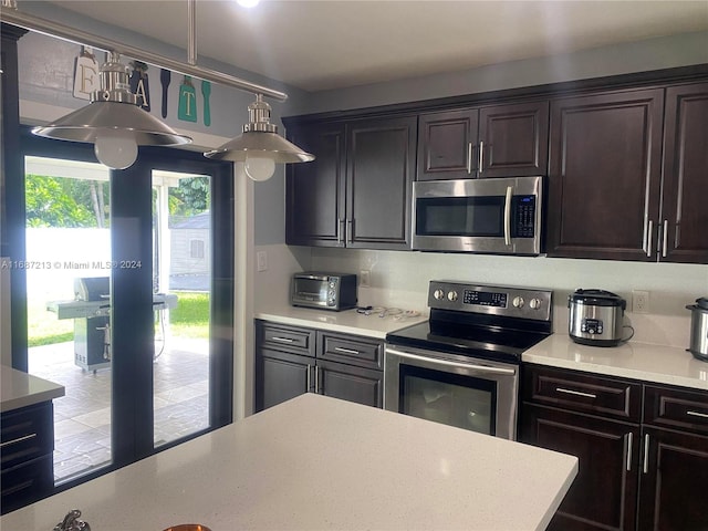 kitchen featuring decorative backsplash, dark brown cabinetry, and stainless steel appliances