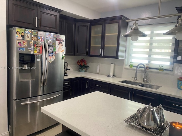 kitchen featuring sink, stainless steel fridge with ice dispenser, and decorative light fixtures