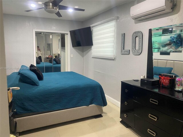 tiled bedroom featuring a closet, ceiling fan, and a wall mounted AC