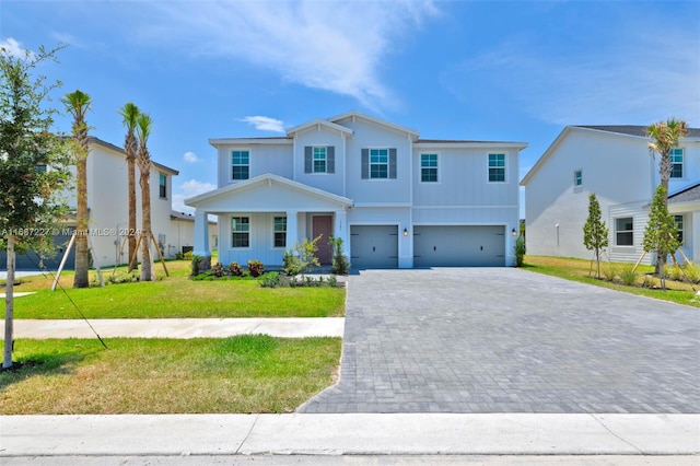 view of front of home with a front lawn and a garage