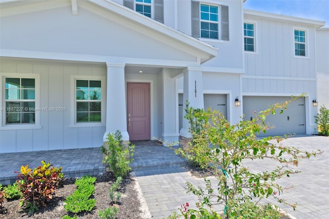 view of exterior entry with a garage