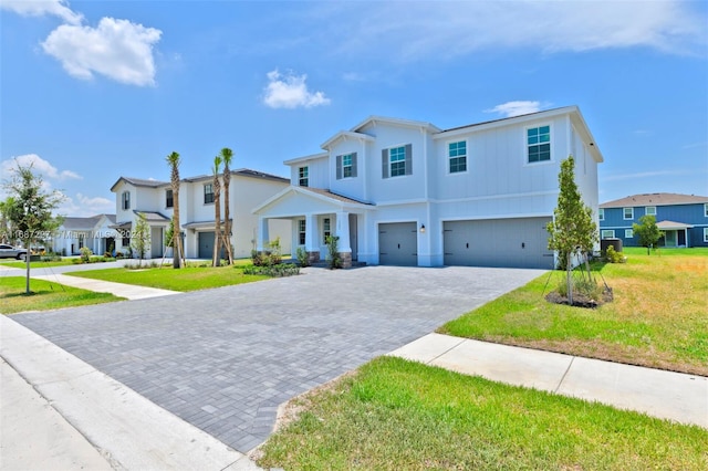 view of front of house featuring a front yard and a garage