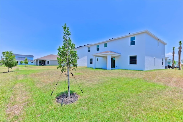 rear view of property with a lawn