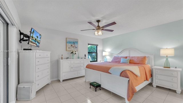 tiled bedroom featuring ceiling fan