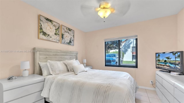 tiled bedroom featuring ceiling fan