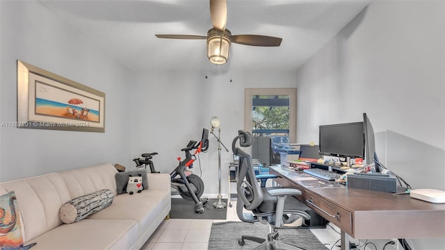 tiled office space featuring a textured ceiling and ceiling fan