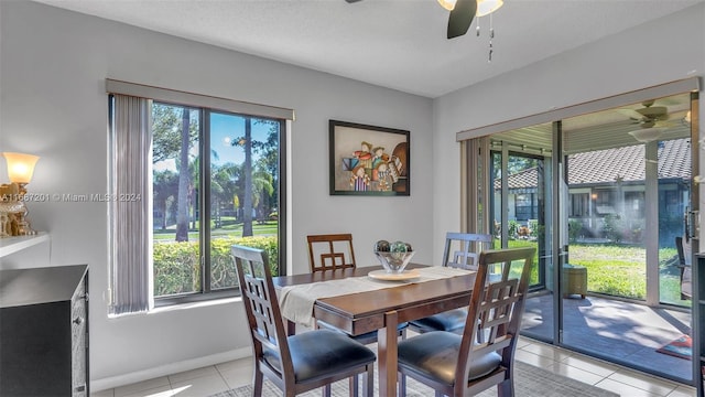 dining area featuring ceiling fan, a healthy amount of sunlight, and light tile patterned floors