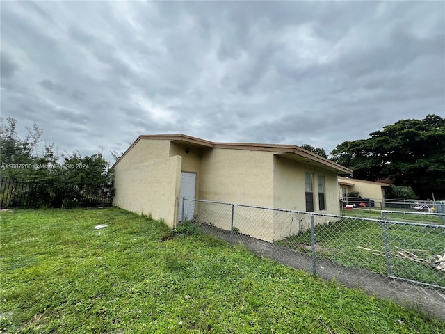 view of side of home featuring a lawn