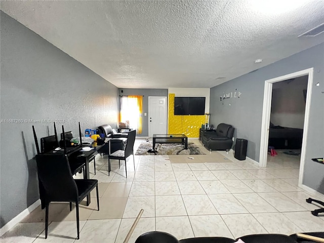 living room with tile patterned floors and a textured ceiling