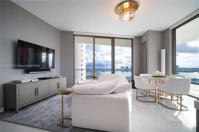 living room featuring a water view and floor to ceiling windows