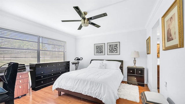 bedroom featuring ceiling fan, ornamental molding, and light hardwood / wood-style flooring