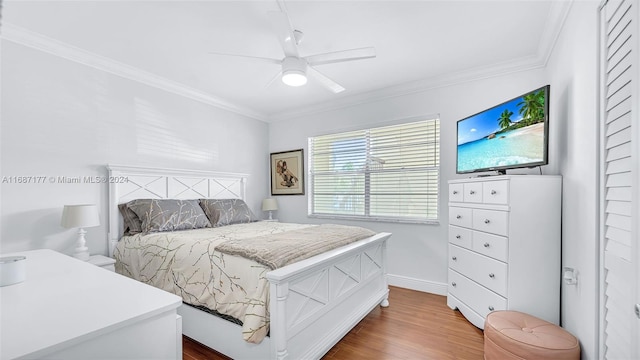 bedroom featuring crown molding, wood-type flooring, and ceiling fan