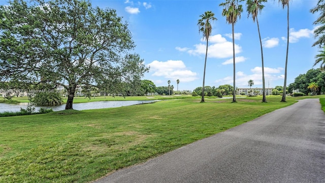 view of home's community featuring a lawn and a water view