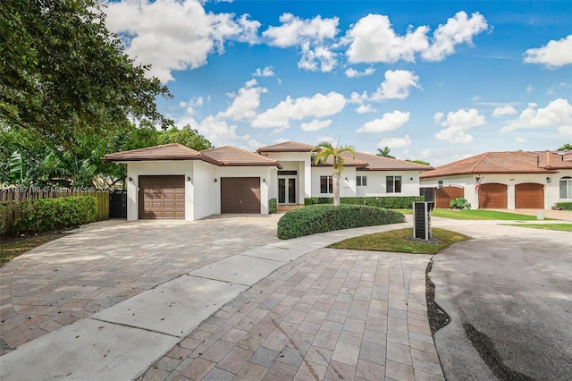 mediterranean / spanish home with a garage