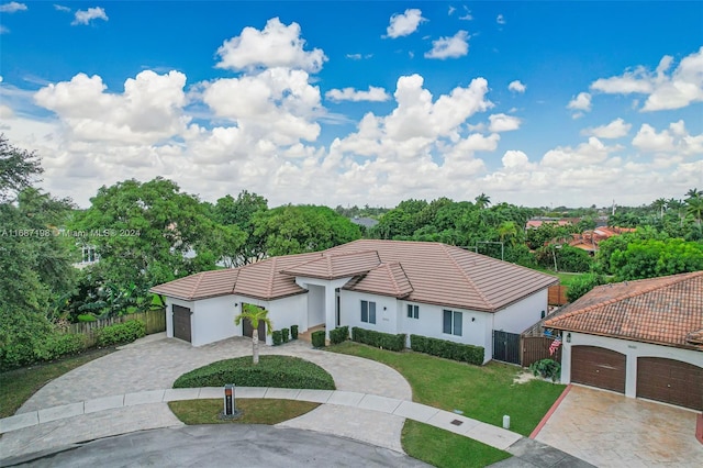 view of front of home featuring a front lawn and a garage