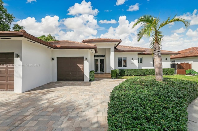 mediterranean / spanish home with a garage