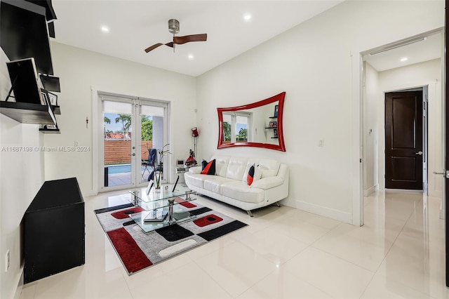 tiled living room featuring french doors and ceiling fan