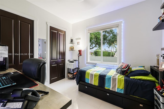 bedroom featuring light tile patterned flooring and a closet