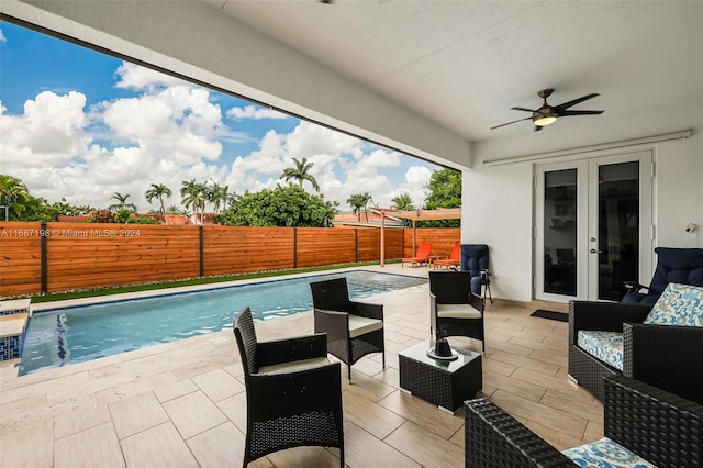 view of pool with a patio area, french doors, ceiling fan, pool water feature, and outdoor lounge area