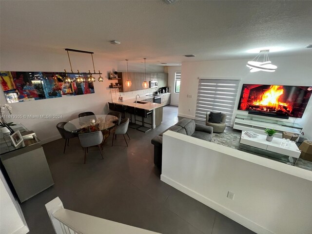 living room with a textured ceiling and sink