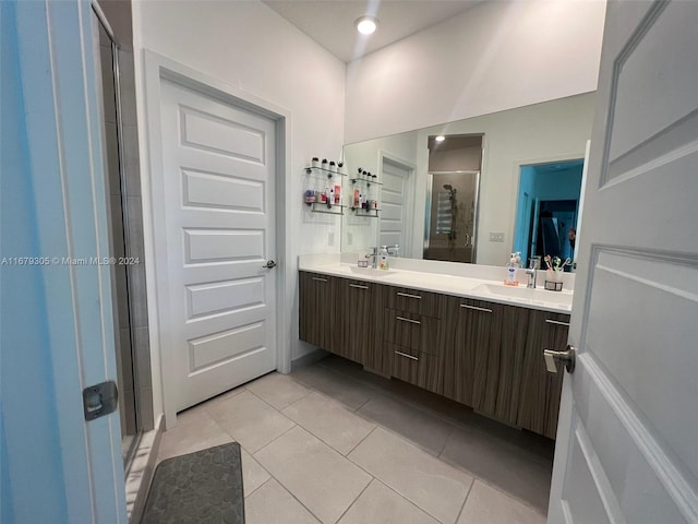 bathroom featuring vanity, tile patterned flooring, and a shower with door