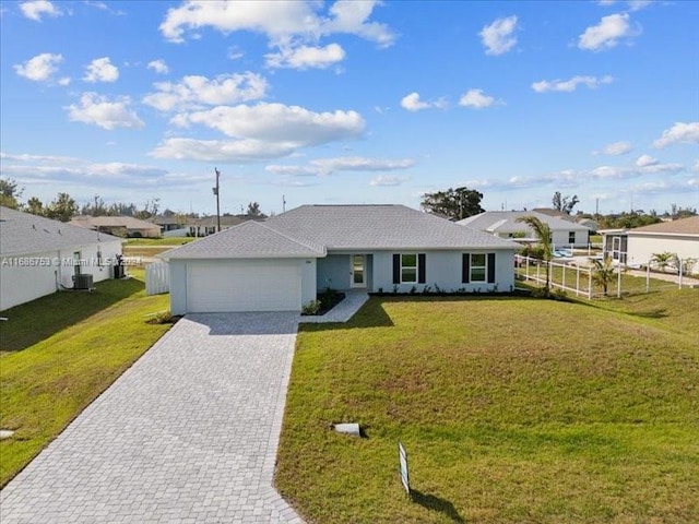 ranch-style home with a front lawn, central AC unit, and a garage