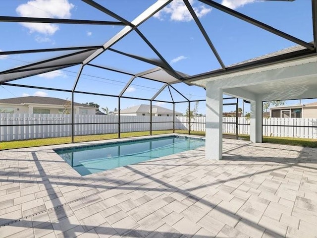 view of swimming pool with a patio and glass enclosure