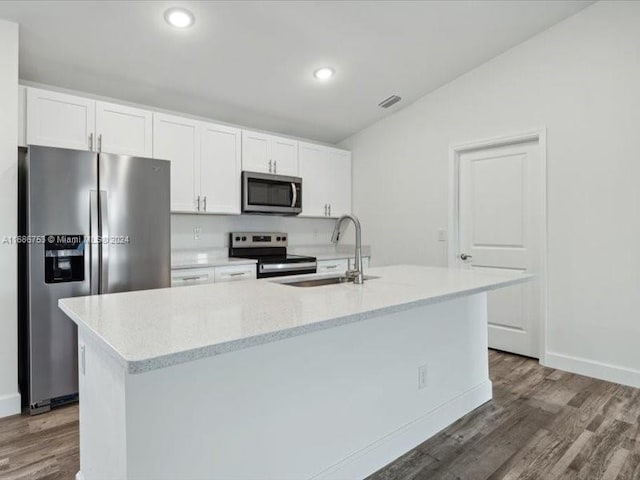 kitchen with appliances with stainless steel finishes, white cabinetry, and a center island with sink