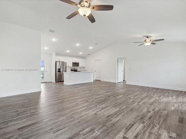 unfurnished living room featuring vaulted ceiling, wood-type flooring, and ceiling fan