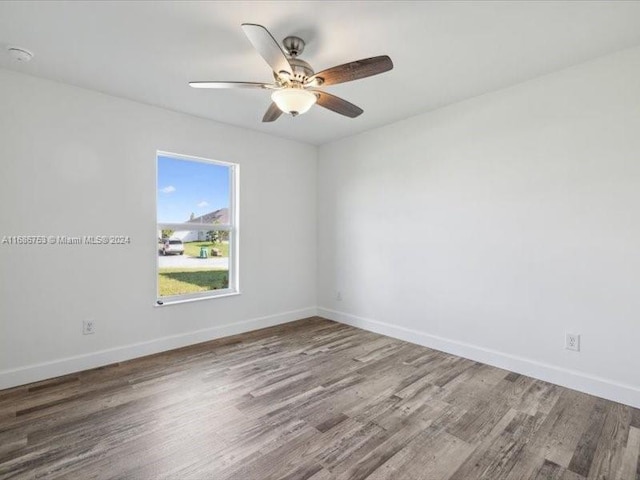 spare room with hardwood / wood-style floors and ceiling fan