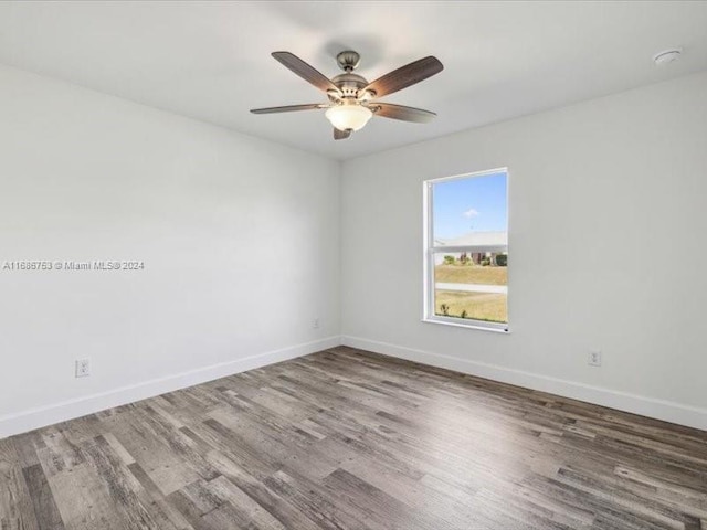 unfurnished room with hardwood / wood-style flooring and ceiling fan