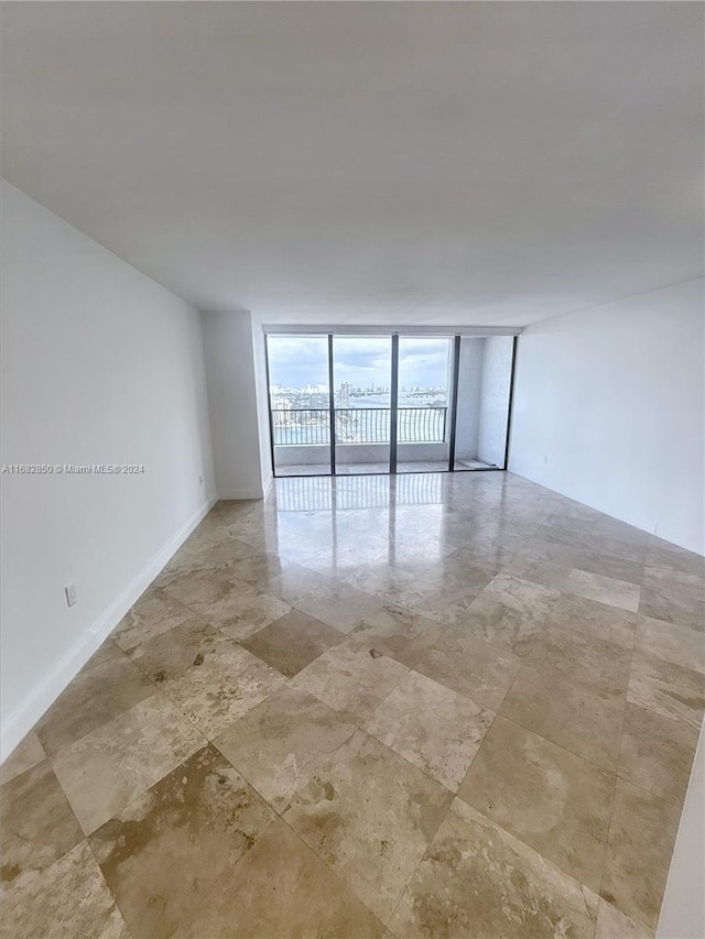 unfurnished room with floor to ceiling windows